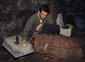 playing a laptop deep
			 underground